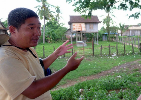 Tin on our tour of Battambang, Cambodia discussing a Khmer Rouge "example home" used for propagandistic purposes