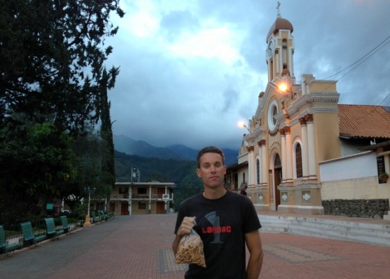 Holding animal crackers in front of the church adjacent to the lively plaza