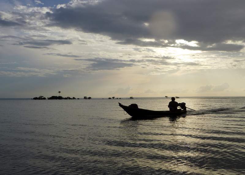 A fisherman returning to his village at sunset along the Rio Tapajós.