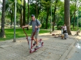 Paul working out (and \"it\") in one of HCMC\'s many beautiful parks.  Note the lady behind him is on a waist twisting disc which I haven\'t seen since I was a child.