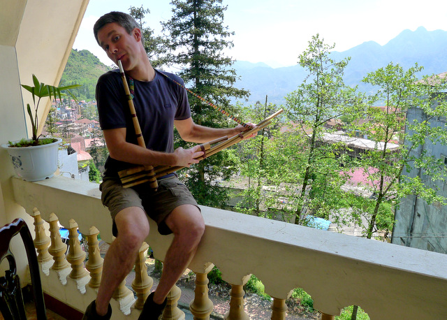 Me playing the H\'Mong flute on the terrace of our third hotel, once a fancy hotel which now caters to a steady flow of congenial backpackers.  The buffet breakfast was delicious!