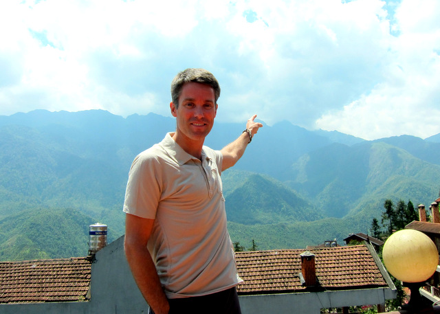 On one of the restaurant terraces pointing to Mt. Fanispan, the highest point in Vietnam and the Indochina region