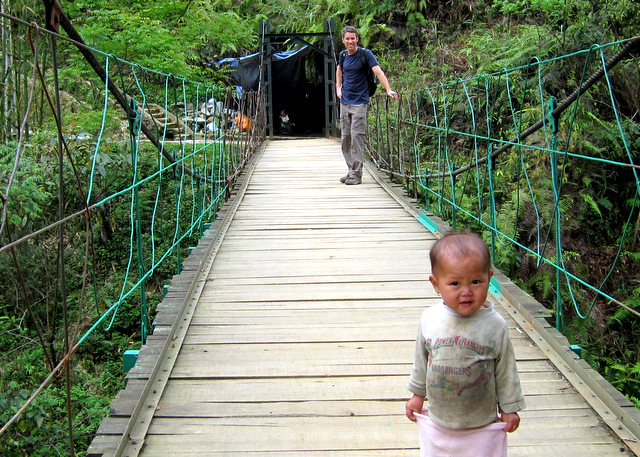 Peter on one of the valley village footbridges, waiting for a H\'Mong tot to pass